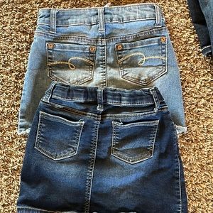 Two youth mini skirts. Dark blue is size 6, lighter blue is size 7